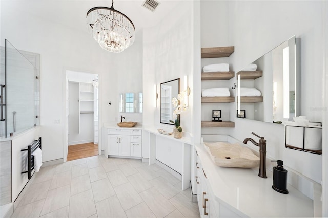 6202 Pasadena Point Blvd, Gulfport, FL 33707 - bathroom featuring vanity, a stall shower, a chandelier, heating unit, and a spacious closet