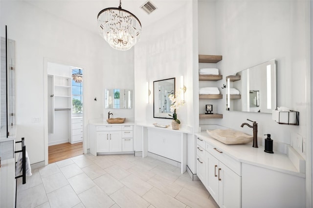 6202 Pasadena Point Blvd, Gulfport, FL 33707 - full bath with a chandelier, a high ceiling, two vanities, and tile patterned flooring