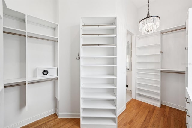 6202 Pasadena Point Blvd, Gulfport, FL 33707 - spacious closet featuring light wood finished floors and a chandelier