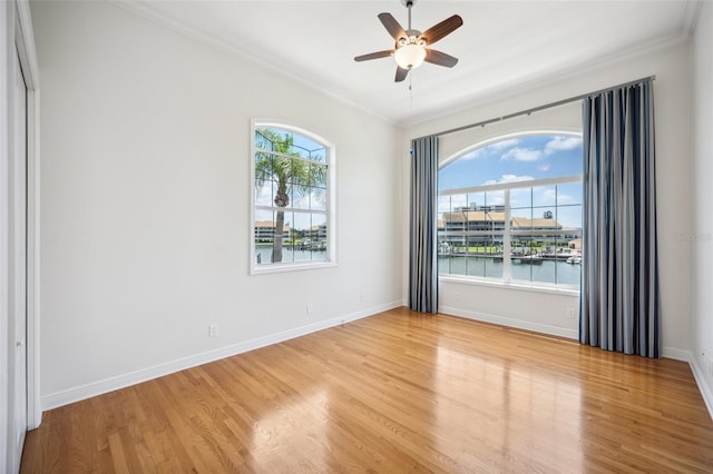 6202 Pasadena Point Blvd, Gulfport, FL 33707 - spare room featuring ornamental molding, ceiling fan, light wood-type flooring, and baseboards