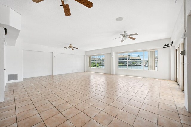 6202 Pasadena Point Blvd, Gulfport, FL 33707 - unfurnished living room with ceiling fan and light tile patterned floors