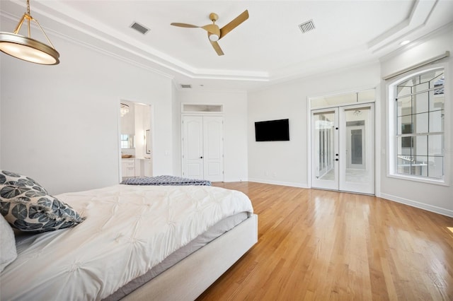6202 Pasadena Point Blvd, Gulfport, FL 33707 - bedroom with light wood-style flooring, access to outside, a tray ceiling, ensuite bath, and a ceiling fan