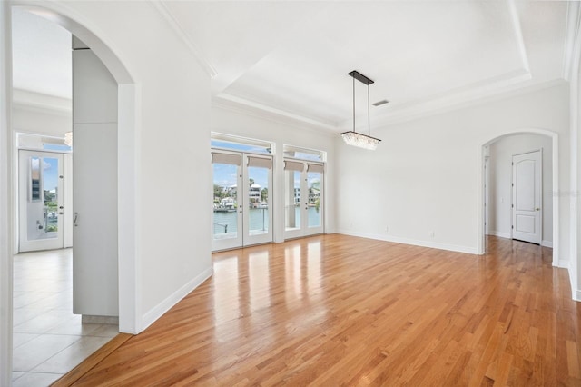 6202 Pasadena Point Blvd, Gulfport, FL 33707 - empty room with arched walkways, crown molding, light wood-type flooring, and baseboards