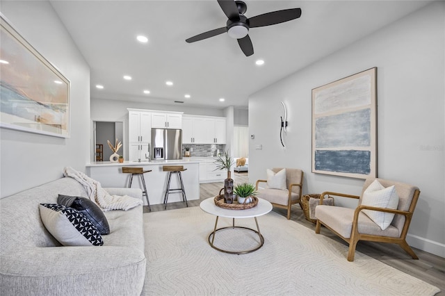 13117 4th St E, Madeira Beach, FL 33708 - living area with light wood finished floors, recessed lighting, ceiling fan, and baseboards