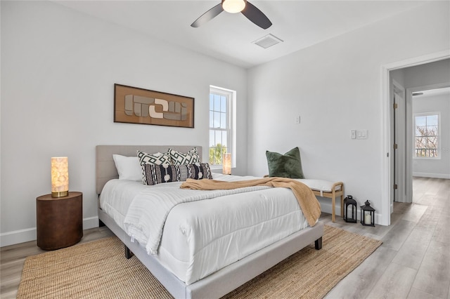 13117 4th St E, Madeira Beach, FL 33708 - bedroom with light wood-style flooring, baseboards, and a ceiling fan