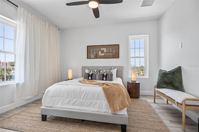 13117 4th St E, Madeira Beach, FL 33708 - bedroom featuring light wood-type flooring, baseboards, and ceiling fan