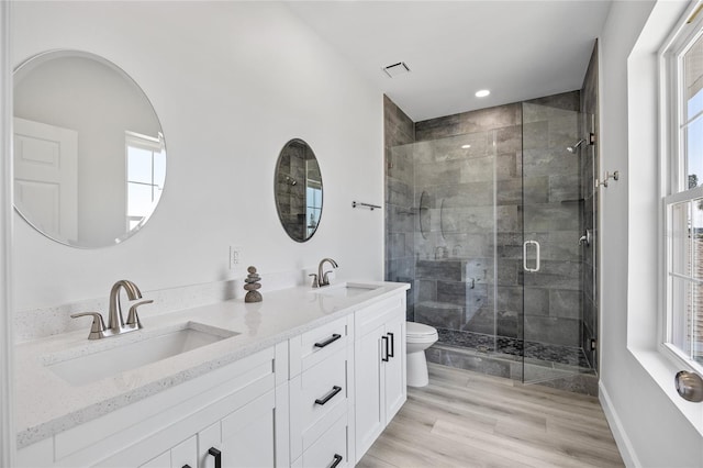13117 4th St E, Madeira Beach, FL 33708 - bathroom featuring toilet, a stall shower, double vanity, healthy amount of natural light, and recessed lighting