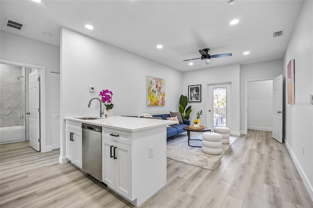 13117 4th St E, Madeira Beach, FL 33708 - kitchen with a sink, stainless steel dishwasher, a ceiling fan, light wood finished floors, and recessed lighting