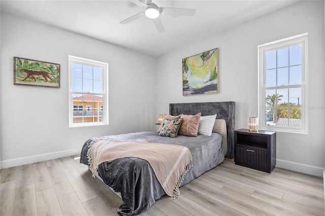 13117 4th St E, Madeira Beach, FL 33708 - bedroom featuring wood finished floors, baseboards, and ceiling fan