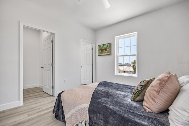 13117 4th St E, Madeira Beach, FL 33708 - bedroom with light wood-type flooring, baseboards, and ceiling fan