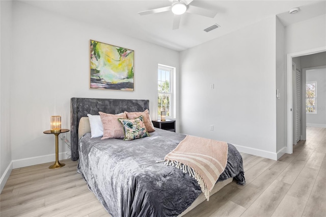 13117 4th St E, Madeira Beach, FL 33708 - bedroom featuring light wood-type flooring, multiple windows, and baseboards