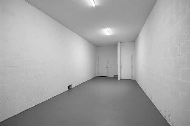 13117 4th St E, Madeira Beach, FL 33708 - unfurnished room with finished concrete floors and concrete block wall