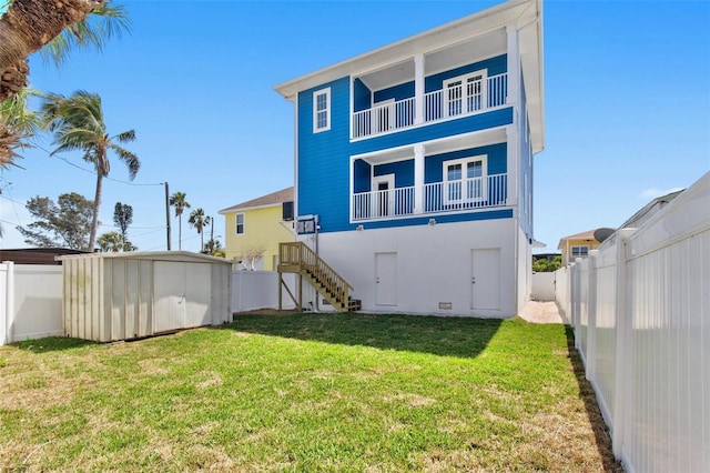 13117 4th St E, Madeira Beach, FL 33708 - back of house featuring a storage shed, an outbuilding, a balcony, and stairs