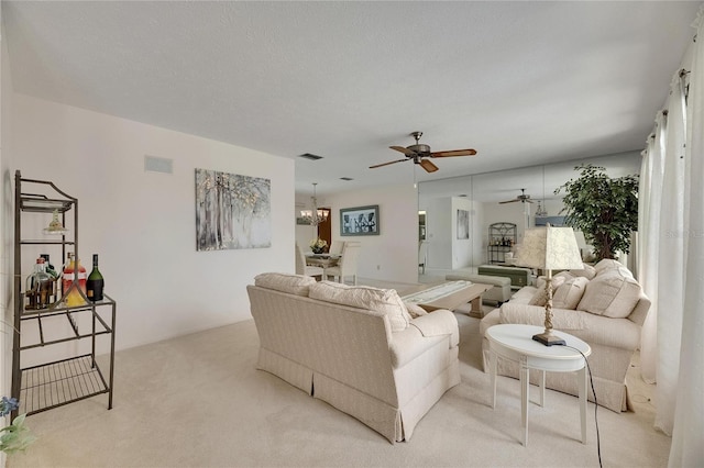 927 Golf Island Dr, Apollo Beach, FL 33572 - living room with light colored carpet, ceiling fan, and a chandelier