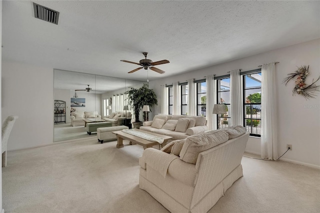 927 Golf Island Dr, Apollo Beach, FL 33572 - living area featuring ceiling fan, light carpet, and a textured ceiling