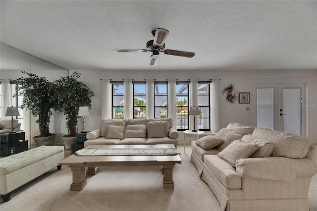 927 Golf Island Dr, Apollo Beach, FL 33572 - living area with french doors, a ceiling fan, carpet, and a textured ceiling
