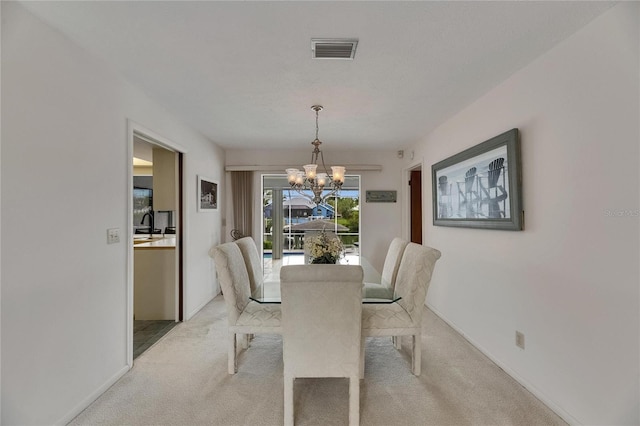 927 Golf Island Dr, Apollo Beach, FL 33572 - dining space with a chandelier, light colored carpet, and baseboards