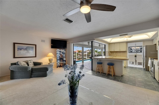 927 Golf Island Dr, Apollo Beach, FL 33572 - kitchen featuring carpet, a kitchen bar, open floor plan, stainless steel electric range oven, and ceiling fan