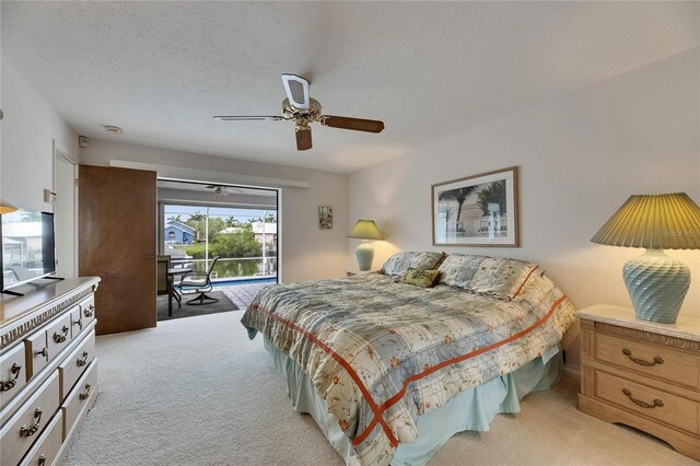 927 Golf Island Dr, Apollo Beach, FL 33572 - bedroom featuring light carpet, access to outside, a ceiling fan, and a textured ceiling