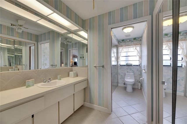 927 Golf Island Dr, Apollo Beach, FL 33572 - bathroom with toilet, wallpapered walls, tile patterned flooring, vanity, and baseboards