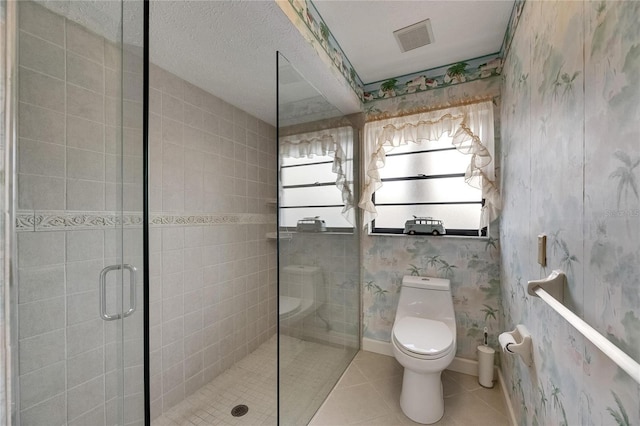927 Golf Island Dr, Apollo Beach, FL 33572 - bathroom with a shower stall, tile patterned flooring, toilet, and wallpapered walls