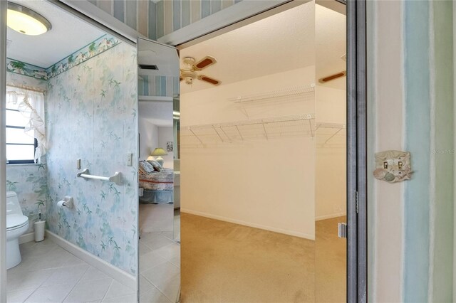 927 Golf Island Dr, Apollo Beach, FL 33572 - bathroom featuring wallpapered walls, toilet, baseboards, and tile patterned flooring