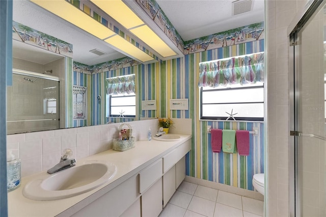 927 Golf Island Dr, Apollo Beach, FL 33572 - bathroom featuring wallpapered walls, tile patterned floors, a shower stall, double vanity, and toilet