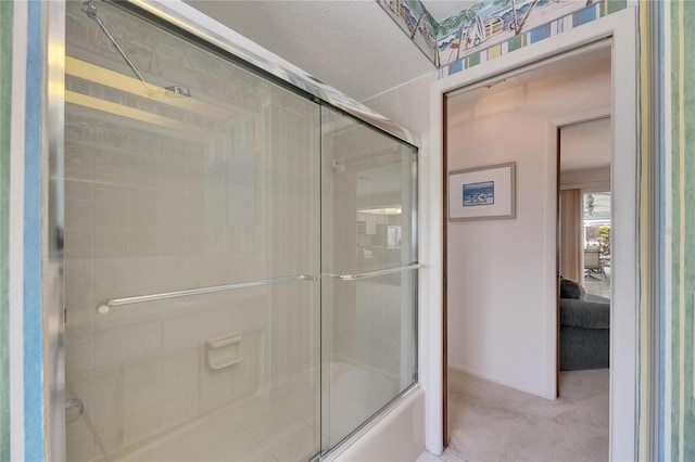 927 Golf Island Dr, Apollo Beach, FL 33572 - bathroom featuring baseboards, shower / bath combination with glass door, and ensuite bath