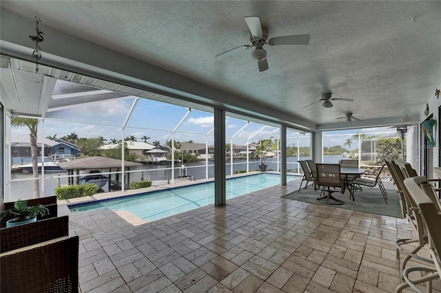927 Golf Island Dr, Apollo Beach, FL 33572 - outdoor pool featuring a patio area, a ceiling fan, glass enclosure, and a water view