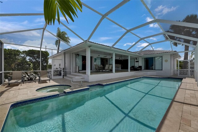 927 Golf Island Dr, Apollo Beach, FL 33572 - rear view of property featuring an in-ground hot tub, a patio, an outdoor pool, and a lanai