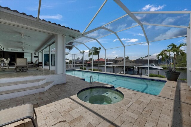 927 Golf Island Dr, Apollo Beach, FL 33572 - view of pool featuring a patio, ceiling fan, glass enclosure, and a pool with connected hot tub