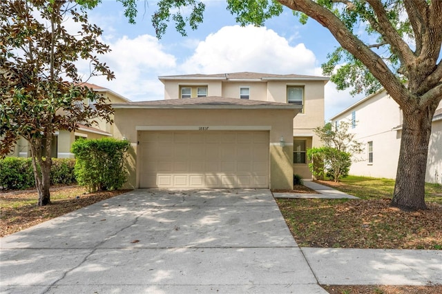 18837 Litzau Ln, Land O Lakes, FL 34638 - view of front facade featuring stucco siding, concrete driveway, and an attached garage