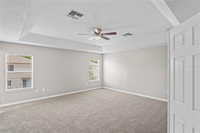 18837 Litzau Ln, Land O Lakes, FL 34638 - unfurnished room featuring a raised ceiling, a ceiling fan, a textured ceiling, carpet flooring, and baseboards