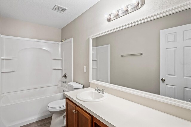 18837 Litzau Ln, Land O Lakes, FL 34638 - full bath featuring toilet, vanity, wood finished floors, and bathing tub / shower combination