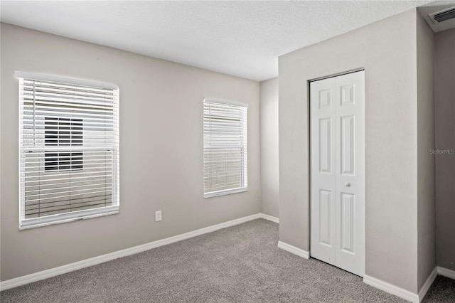 18837 Litzau Ln, Land O Lakes, FL 34638 - unfurnished bedroom with a closet, carpet, and baseboards