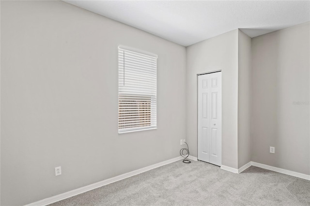 18837 Litzau Ln, Land O Lakes, FL 34638 - unfurnished bedroom with carpet, baseboards, and a closet