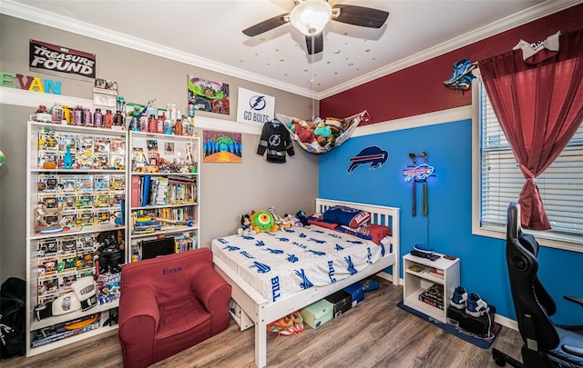 bedroom featuring baseboards, ornamental molding, a ceiling fan, and wood finished floors