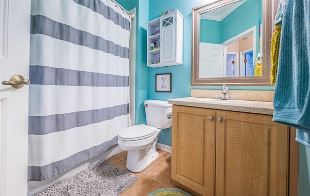 bathroom featuring a shower with curtain, tile patterned floors, vanity, and toilet
