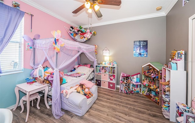 bedroom with baseboards, ornamental molding, wood finished floors, and multiple windows