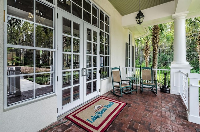 exterior space with a porch and french doors