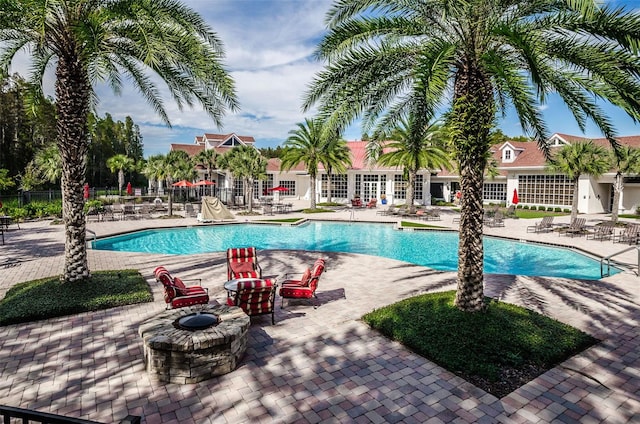community pool featuring a patio area and fence