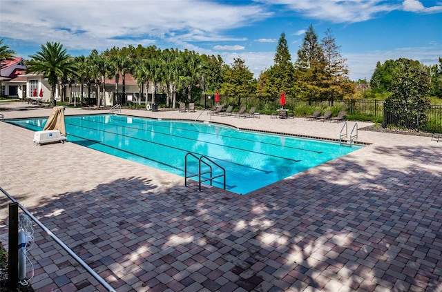 pool featuring a patio and fence