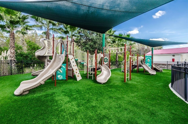 communal playground with fence and a yard