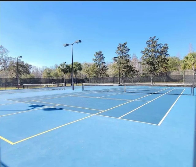 view of sport court featuring fence and community basketball court