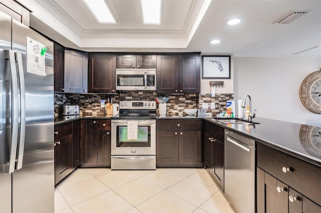19418 Gulf Blvd Unit 507, Indian Shores, FL 33785 - kitchen featuring stainless steel appliances, dark countertops, dark brown cabinetry, backsplash, and recessed lighting