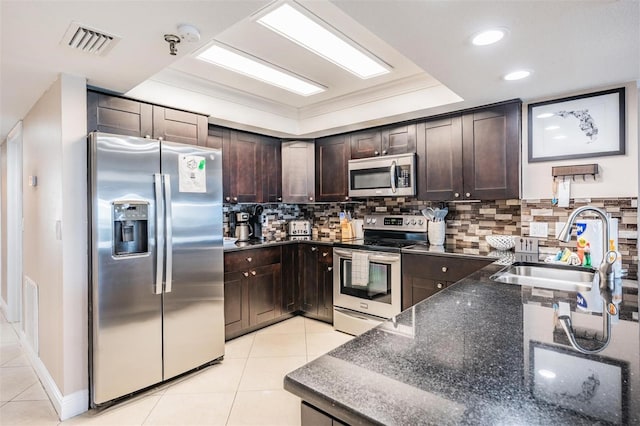 19418 Gulf Blvd Unit 507, Indian Shores, FL 33785 - kitchen featuring stainless steel appliances, dark brown cabinetry, light tile patterned floors, ornamental molding, and recessed lighting