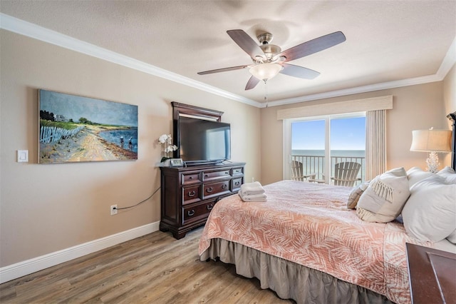 19418 Gulf Blvd Unit 507, Indian Shores, FL 33785 - bedroom featuring light wood finished floors, access to exterior, crown molding, and a ceiling fan