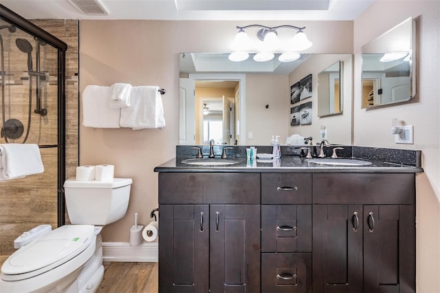 19418 Gulf Blvd Unit 507, Indian Shores, FL 33785 - bathroom with a shower stall, double vanity, and wood finished floors