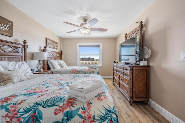 19418 Gulf Blvd Unit 507, Indian Shores, FL 33785 - bedroom featuring light wood-type flooring and a ceiling fan