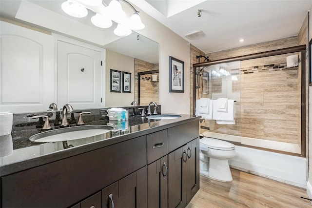 19418 Gulf Blvd Unit 507, Indian Shores, FL 33785 - full bath featuring double vanity, combined bath / shower with glass door, and wood finished floors